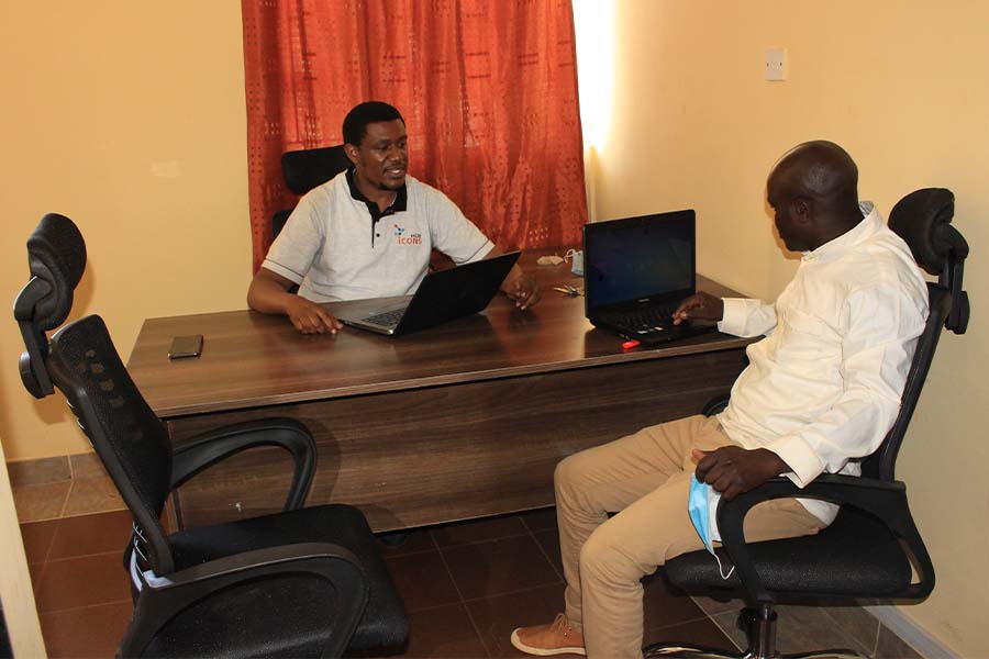 Cyprian Ratemo with a client at Icons Hub boardroom